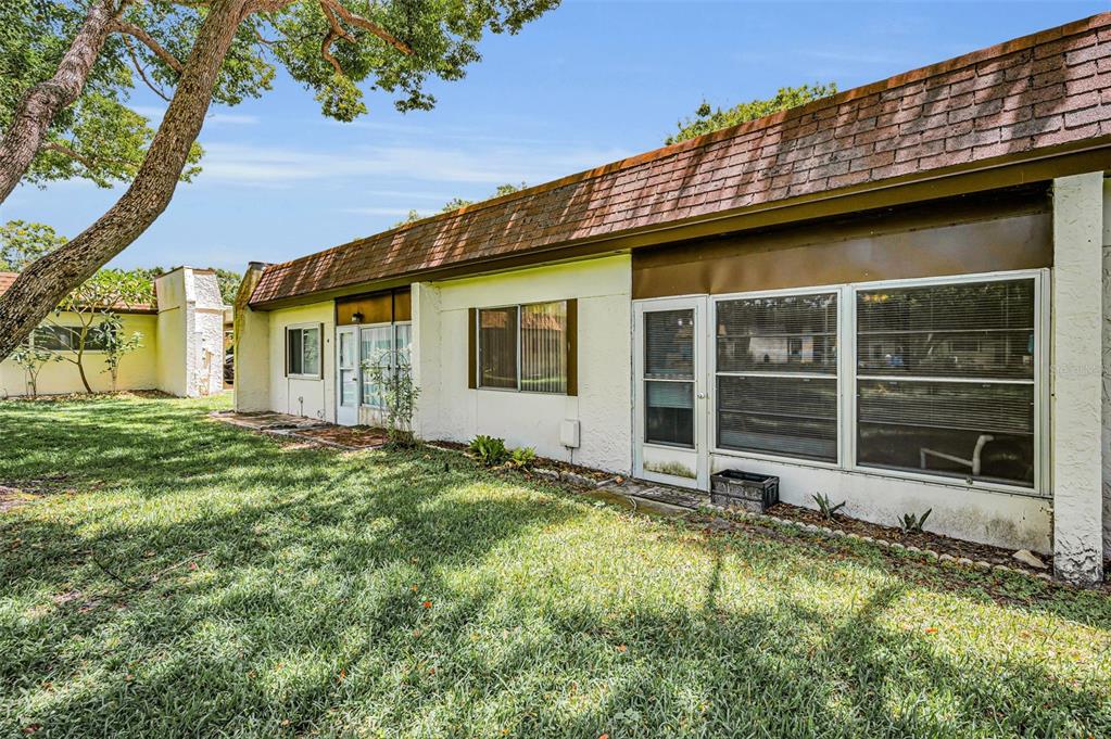 3116 Highlands Boulevard, Unit 3116 Palm Harbor, FL 34684 - Photo 37 of 56 a view of a house with a yard