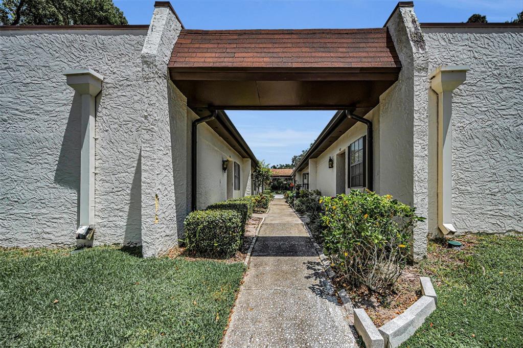 3116 Highlands Boulevard, Unit 3116 Palm Harbor, FL 34684 - Photo 4 of 56 a front view of a house with garden