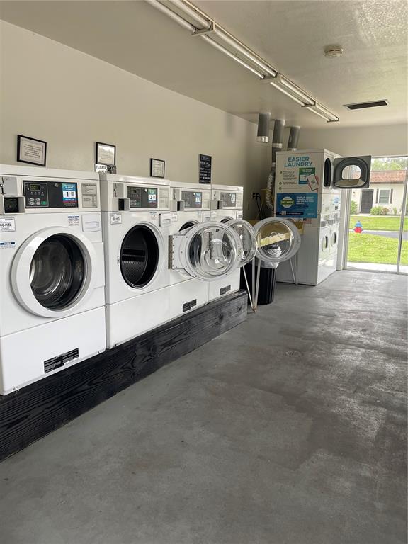 3116 Highlands Boulevard, Unit 3116 Palm Harbor, FL 34684 - Photo 44 of 56 a utility room with dryer and washer