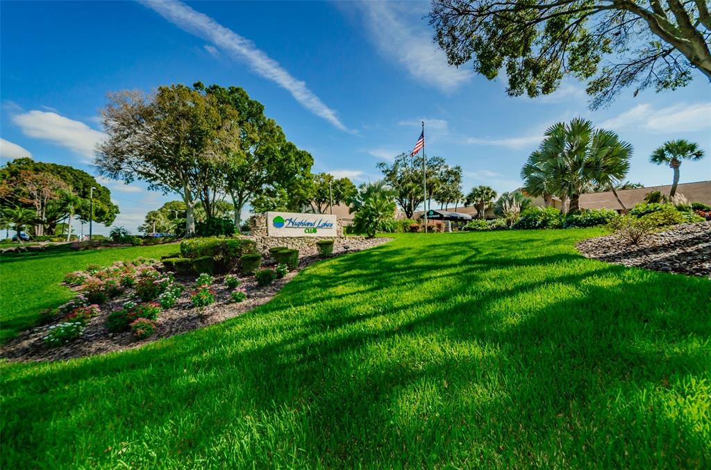 3116 Highlands Boulevard, Unit 3116 Palm Harbor, FL 34684 - Photo 50 of 56 a view of a garden with a building in the background