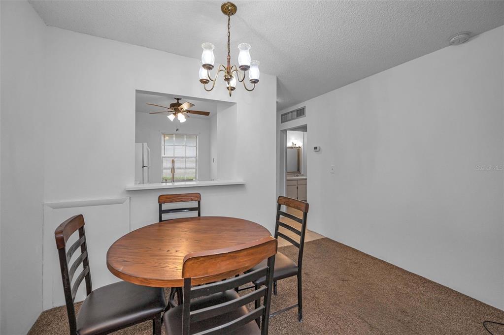 3116 Highlands Boulevard, Unit 3116 Palm Harbor, FL 34684 - Photo 8 of 56 a dining room with furniture and chandelier