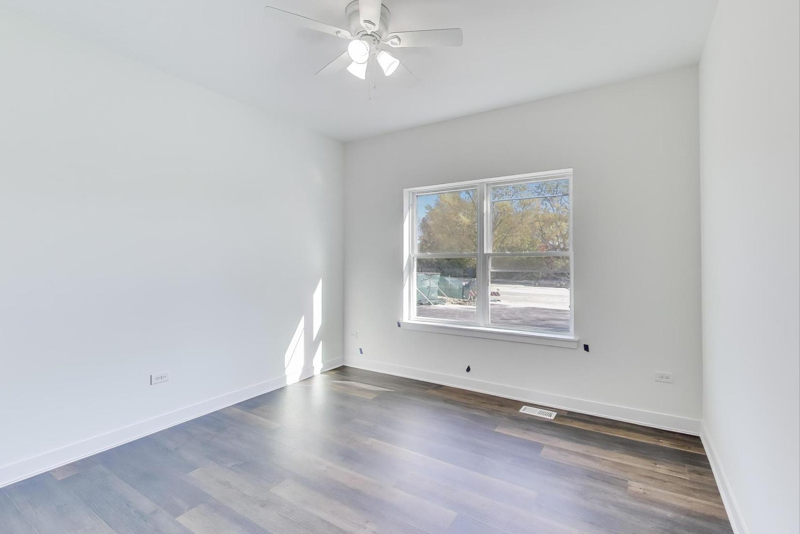 898 North Quentin Road Palatine, IL 60067 - Photo 19 of 28 an empty room with wooden floor and windows