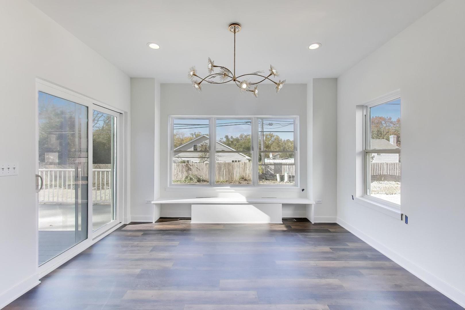 898 North Quentin Road Palatine, IL 60067 - Photo 7 of 28 a view of an empty room with a window and wooden floor