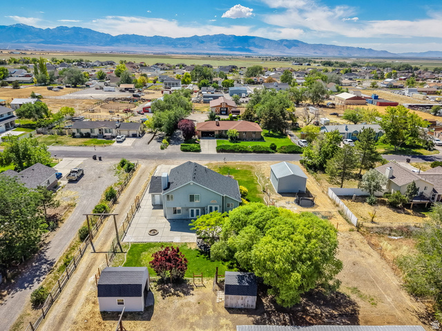 3732 Campbell Road Tooele, UT 84074 - Photo 67 of 69 Aerial perspective showcasing a residential property with surrounding neighborhood and distant mountains