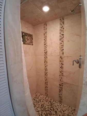 a bedroom with two beds and a chandelier