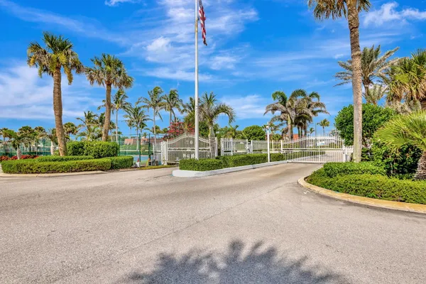 a view of a tall building with a yard and plants
