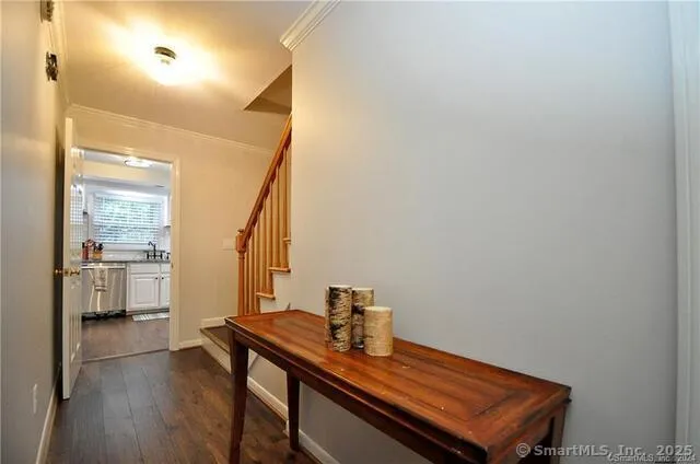 a view of a hallway with workspace and wooden floor