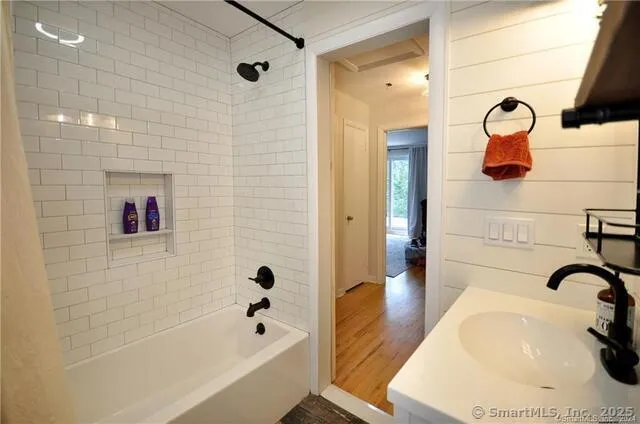 a bathroom with a bathtub and shower