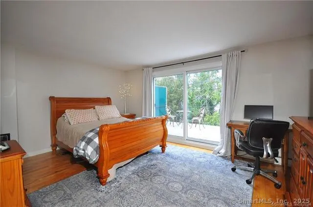 a bed room with a bed and a chair