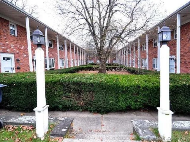 a front view of a building with garden