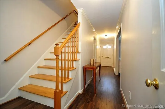 a view of entryway and hall with wooden floor