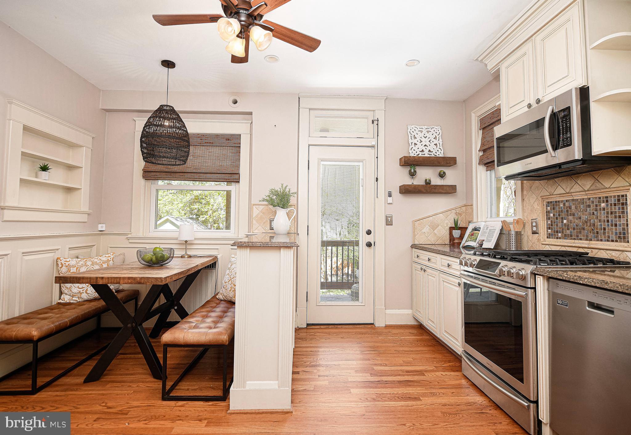 722 Anneslie Road Baltimore, MD 21212 - Photo 12 of 46 a kitchen with stainless steel appliances granite countertop a stove top oven a sink a counter space and cabinets