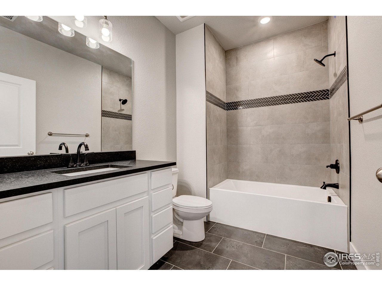 265 High Point Drive, Unit 203 Longmont, CO 80504 - Photo 15 of 24 a bathroom with a sink a toilet and a bathtub