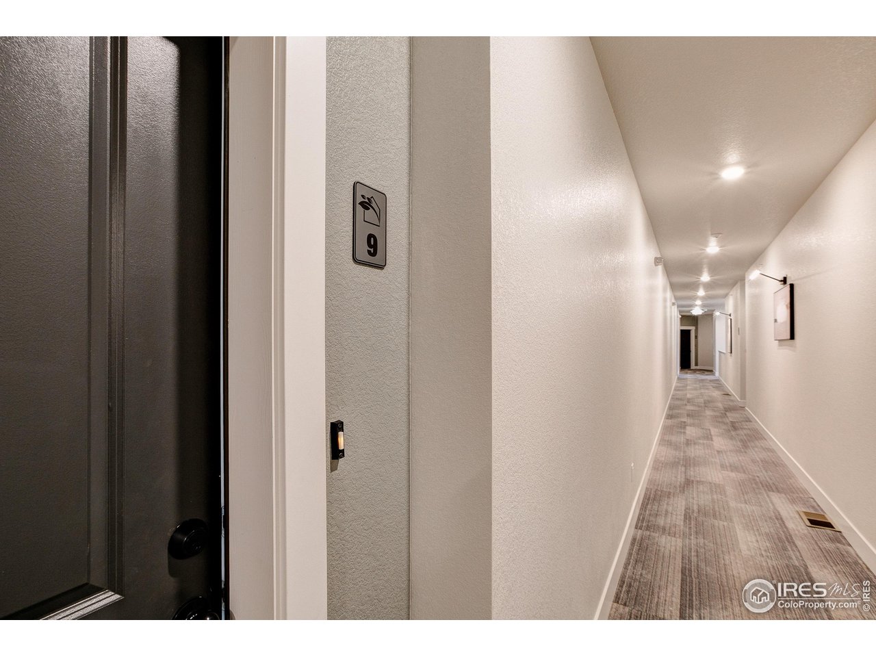 265 High Point Drive, Unit 203 Longmont, CO 80504 - Photo 18 of 24 a view of a hallway with wooden floor