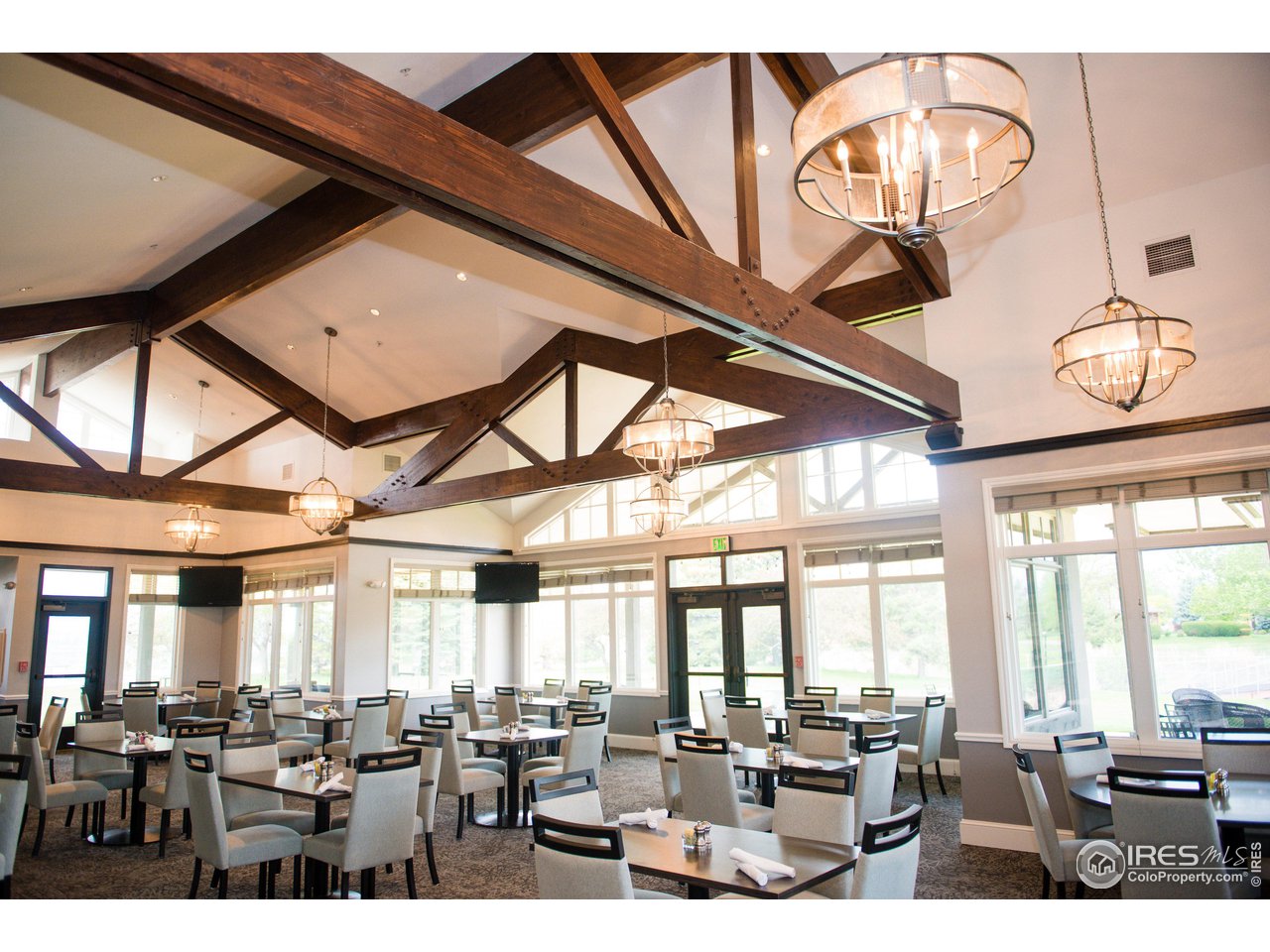265 High Point Drive, Unit 203 Longmont, CO 80504 - Photo 22 of 24 a living room with lots of furniture and a large window