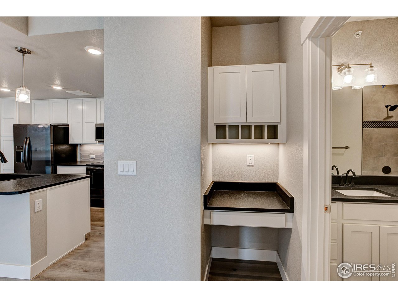 265 High Point Drive, Unit 203 Longmont, CO 80504 - Photo 9 of 24 a kitchen with cabinets and stainless steel appliances