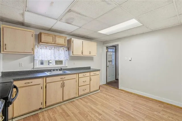 a kitchen with granite countertop white cabinets and white appliances