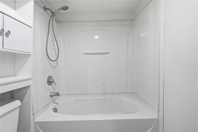 a bathroom with a shower and a window