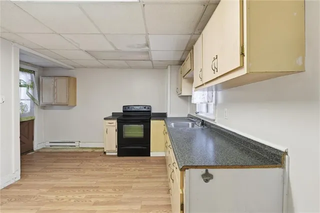 a kitchen with a sink appliances and cabinets