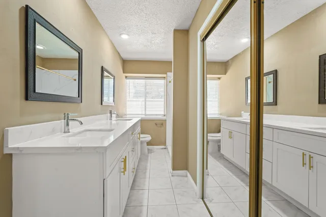 a bathroom with a sink a toilet and mirror