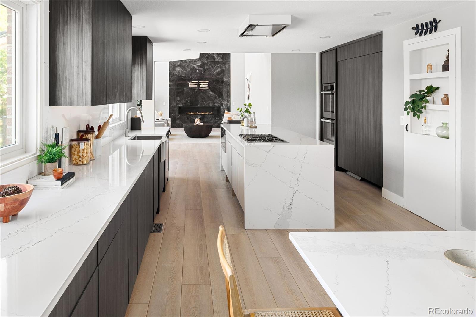7400 South Genoa Circle Centennial, CO 80016 - Photo 1 of 50 a living room with stainless steel appliances furniture wooden floor and a view of kitchen
