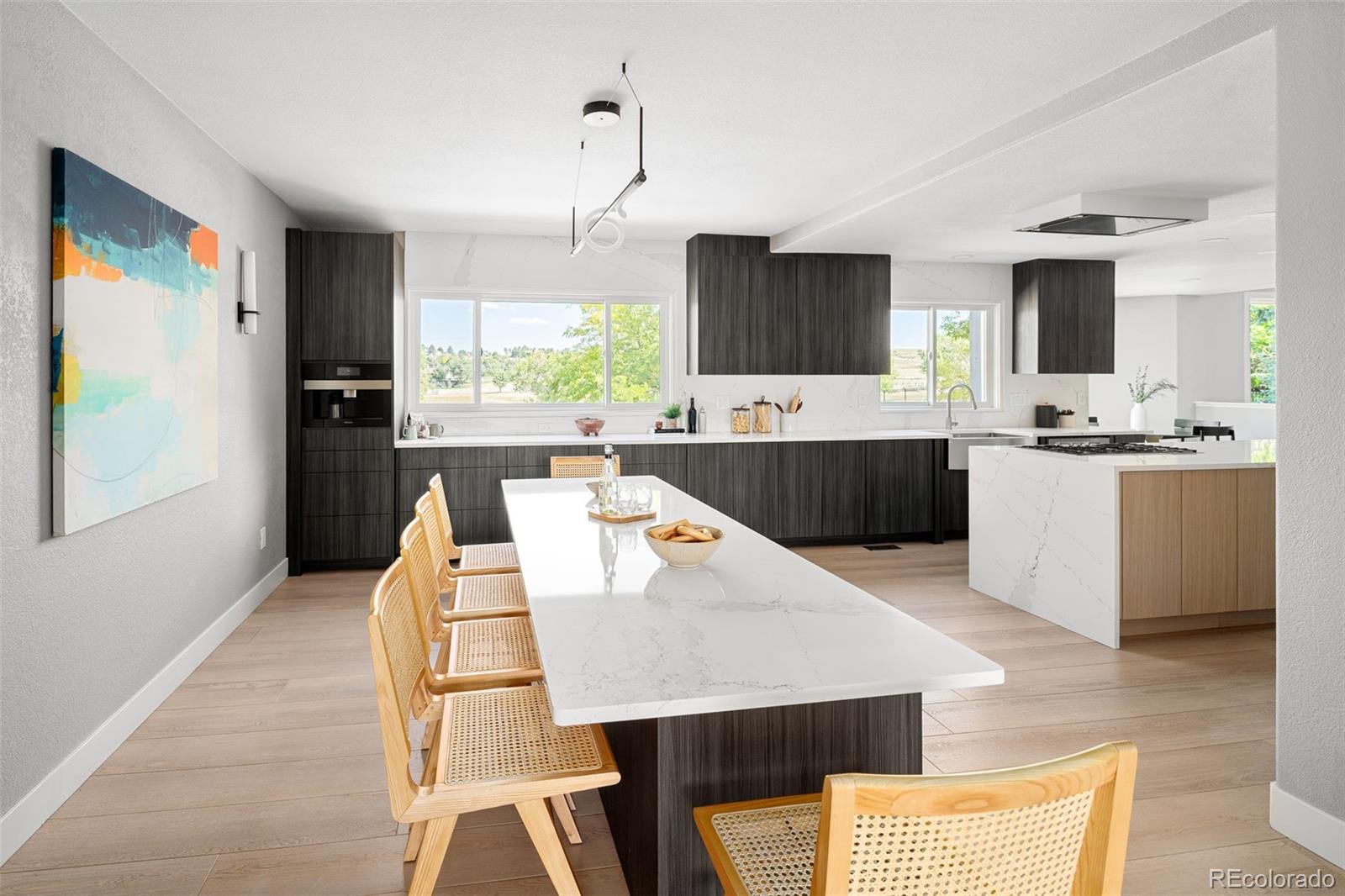 7400 South Genoa Circle Centennial, CO 80016 - Photo 17 of 50 a large kitchen with kitchen island a sink a counter space and stainless steel appliances