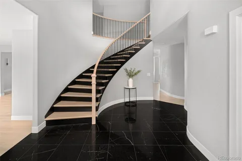 a bathroom with a toilet a sink a tub and mirror