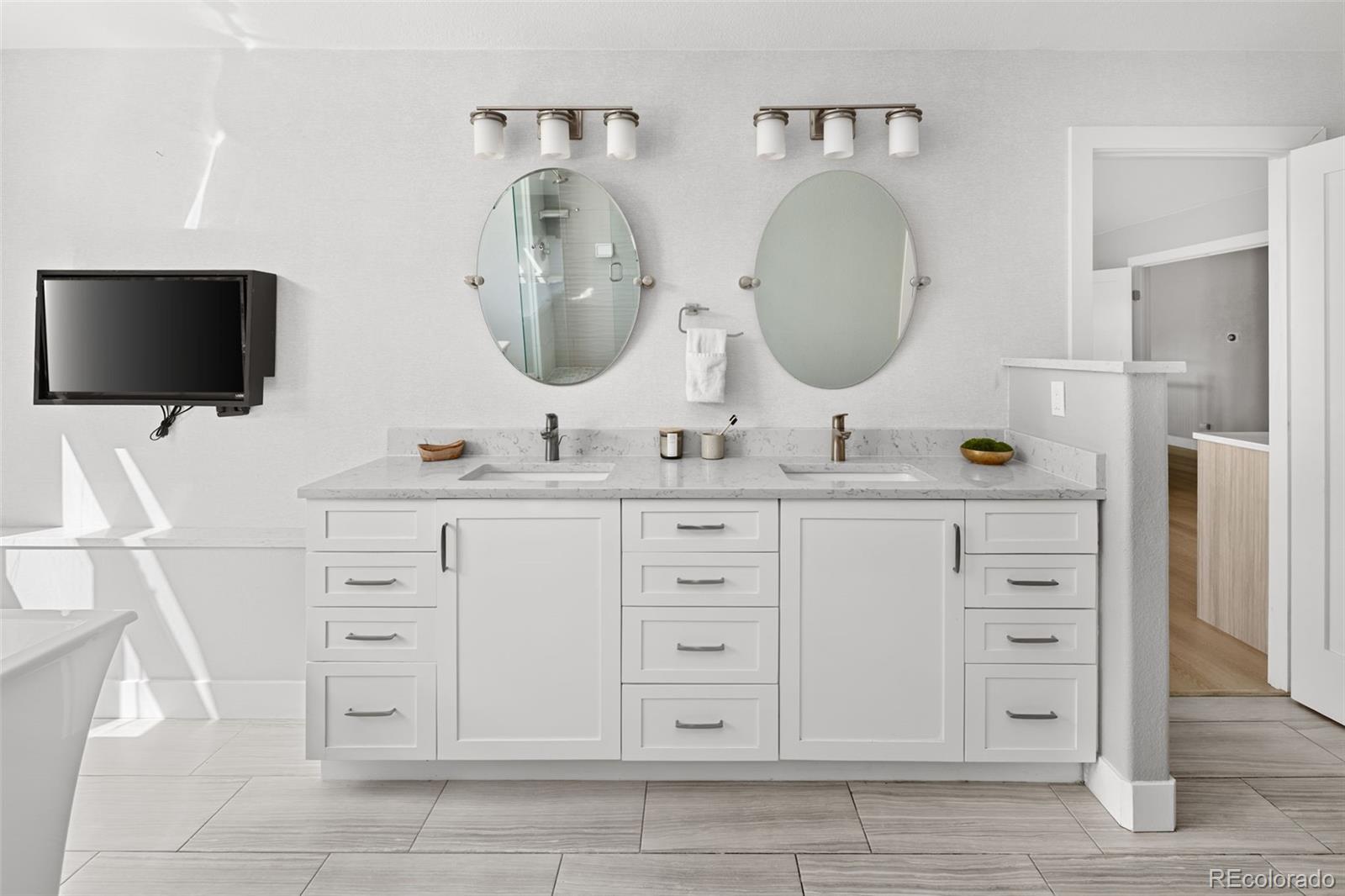 7400 South Genoa Circle Centennial, CO 80016 - Photo 26 of 50 a bathroom with a double vanity sink and a mirror