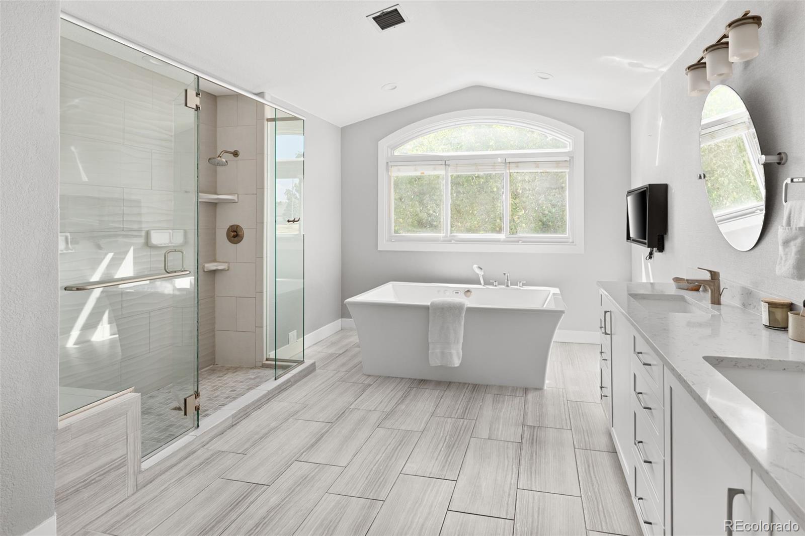 7400 South Genoa Circle Centennial, CO 80016 - Photo 27 of 50 a bathroom with a tub sink and mirror