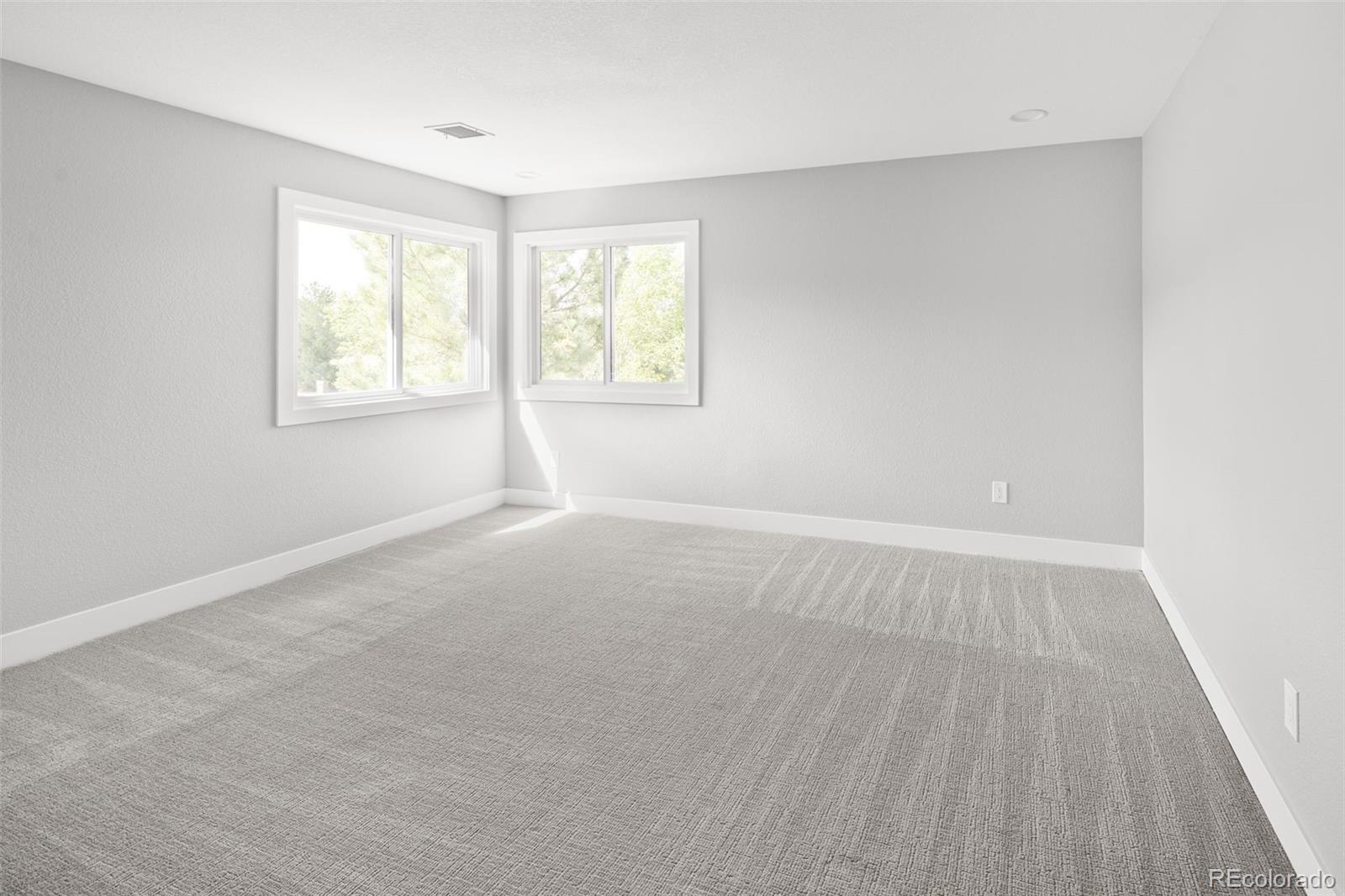 7400 South Genoa Circle Centennial, CO 80016 - Photo 28 of 50 an empty room with wooden floor and windows