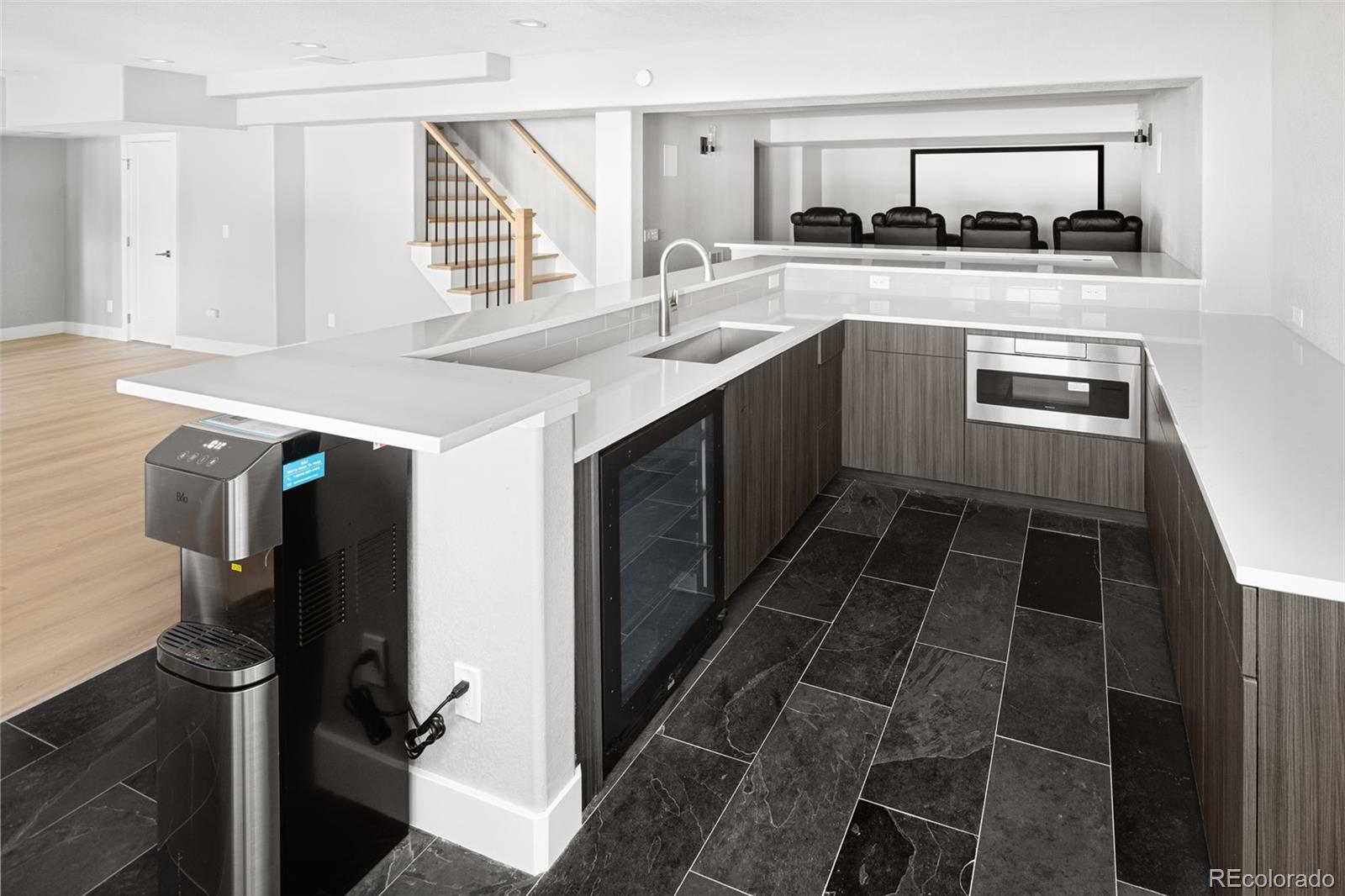 7400 South Genoa Circle Centennial, CO 80016 - Photo 36 of 50 a kitchen with stainless steel appliances a sink stove and cabinets