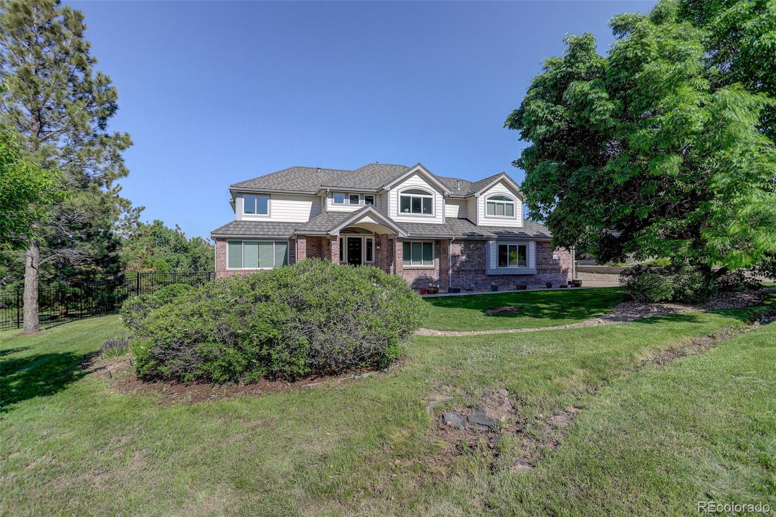 7400 South Genoa Circle Centennial, CO 80016 - Photo 4 of 50 a front view of a house with a garden