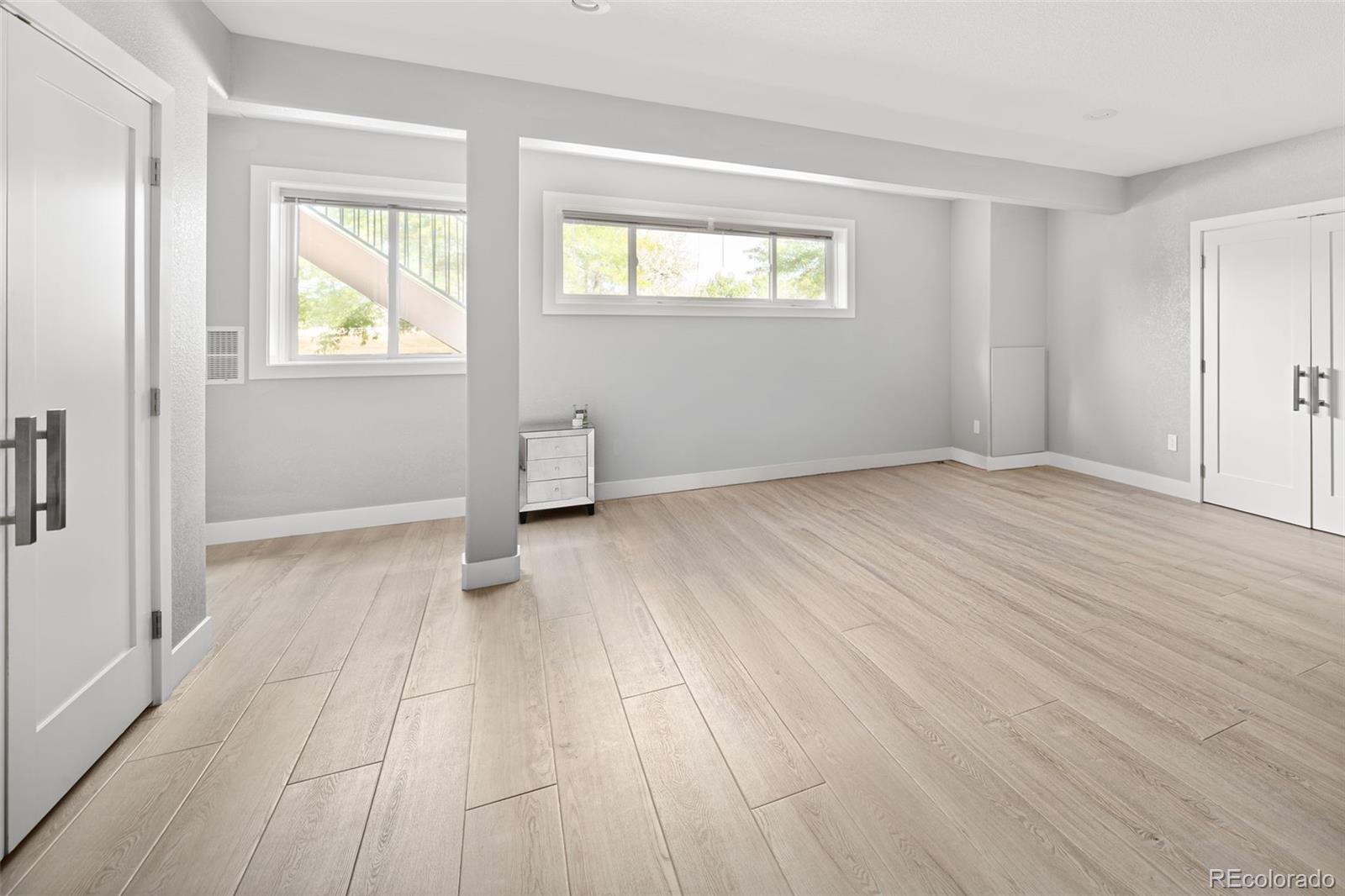 7400 South Genoa Circle Centennial, CO 80016 - Photo 42 of 50 a view of an empty room with wooden floor and a window