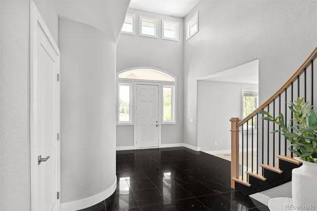 a bathroom with a sink and mirror with bathtub