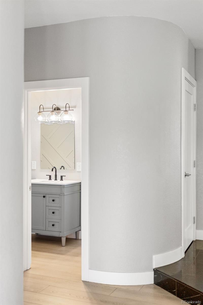 7400 South Genoa Circle Centennial, CO 80016 - Photo 6 of 50 a room with a chair and a wooden floor