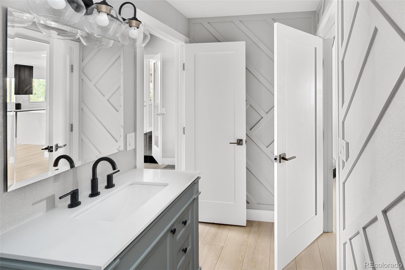 7400 South Genoa Circle Centennial, CO 80016 - Photo 7 of 50 a bathroom with a sink and mirror with bathtub