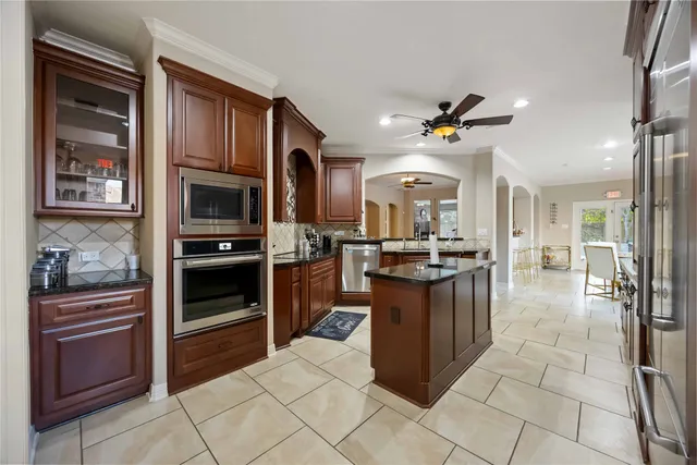 a kitchen with stainless steel appliances granite countertop a stove and a refrigerator