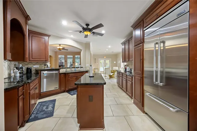 a kitchen with stainless steel appliances granite countertop a refrigerator a oven a sink and dishwasher