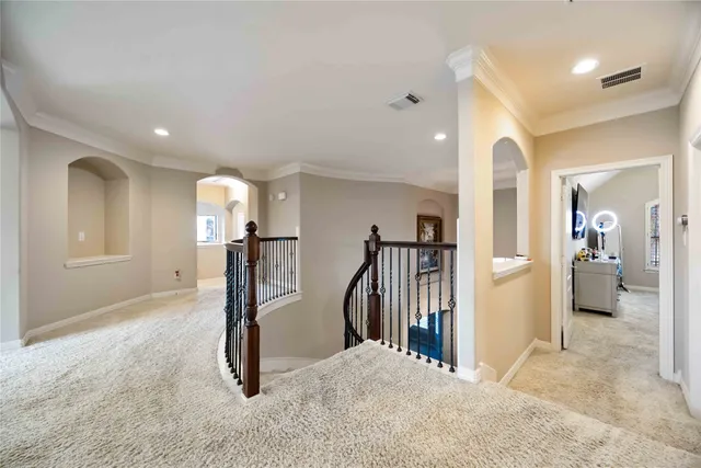 a view of a hallway with a livingroom and stairs