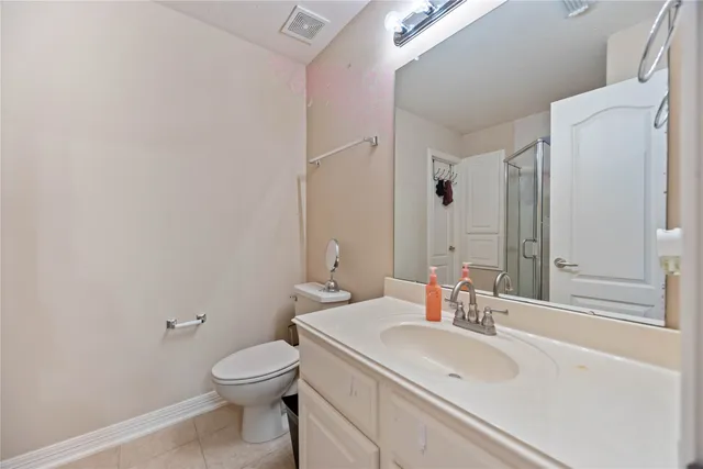 a bathroom with a sink toilet and mirror