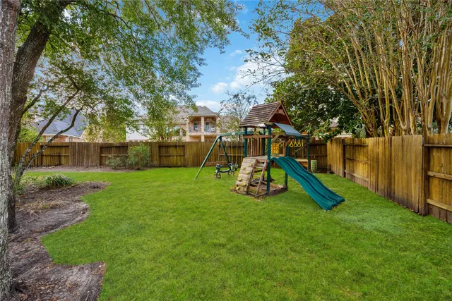 a view of a park with slide and a bench