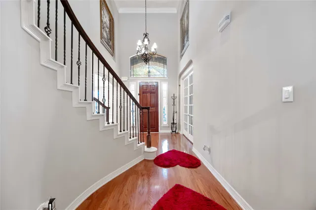 a view of entryway and hall with wooden floor