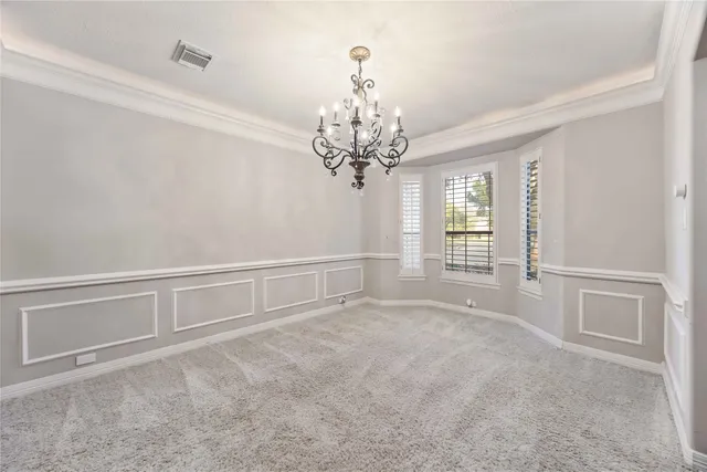 a view of a chandelier in big room and chandelier fan