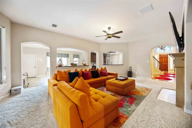 a living room with furniture a fireplace and a flat screen tv