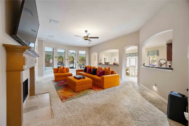 a living room with furniture fireplace and flat screen tv
