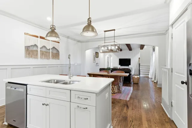 a view of living room kitchen island and stainless steel appliances