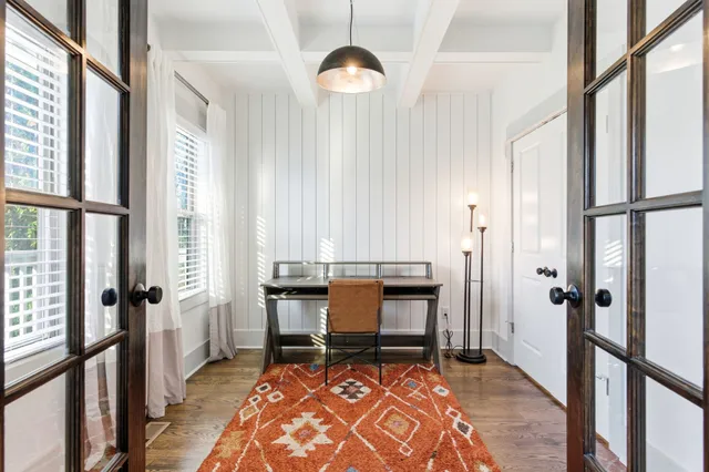 a view of a workspace with furniture and a window