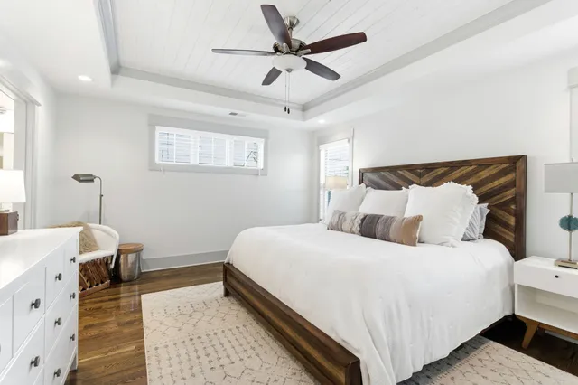a bedroom with bed and a chandelier