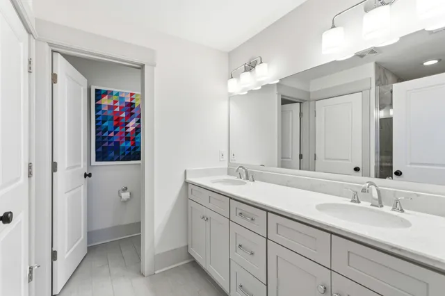 a bathroom with a double vanity sink and a mirror