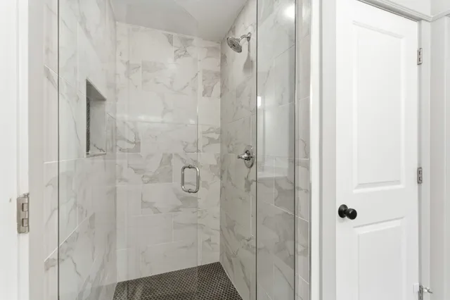 a bathroom with a glass shower door
